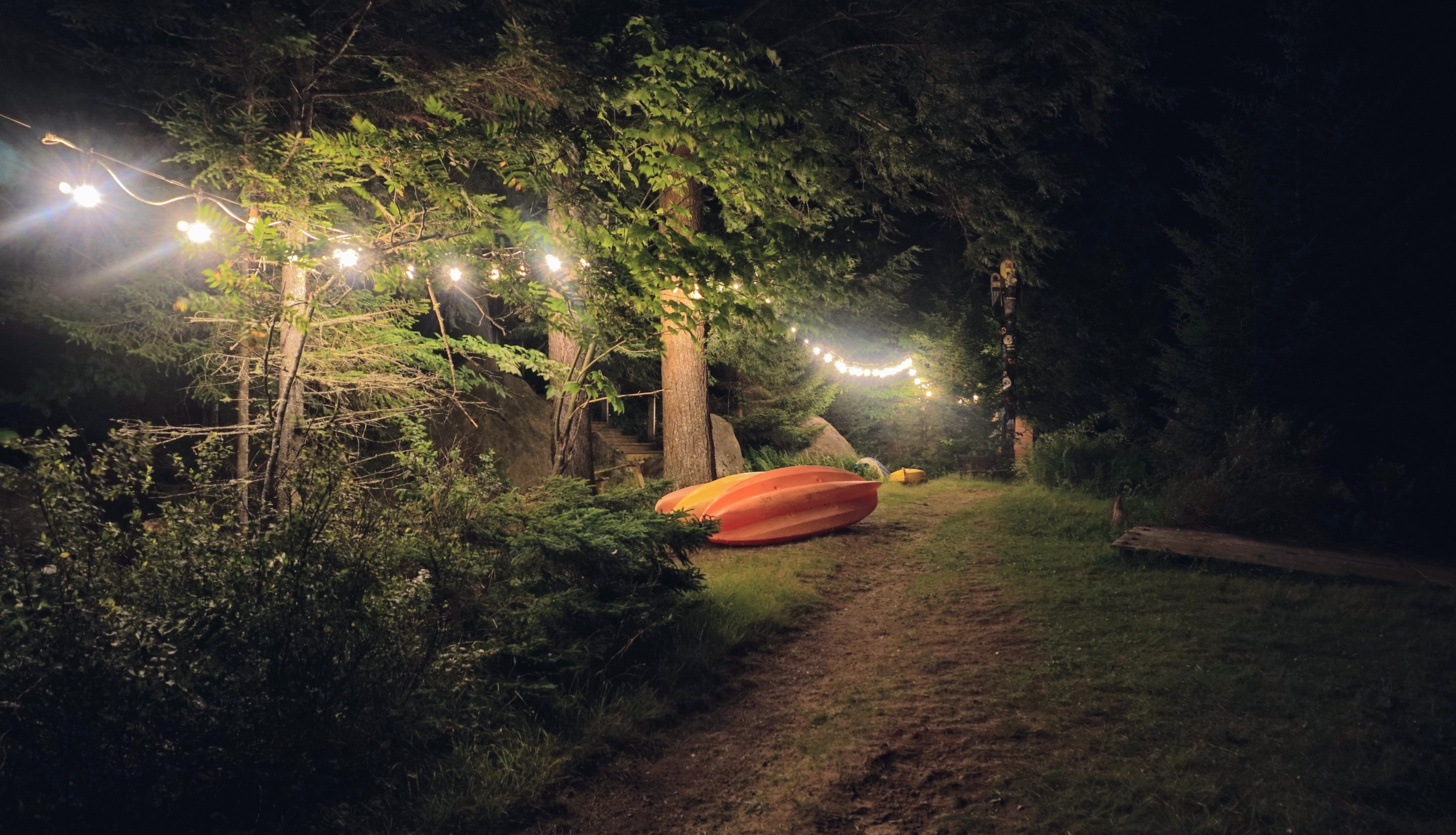 A kayak under string lights at night